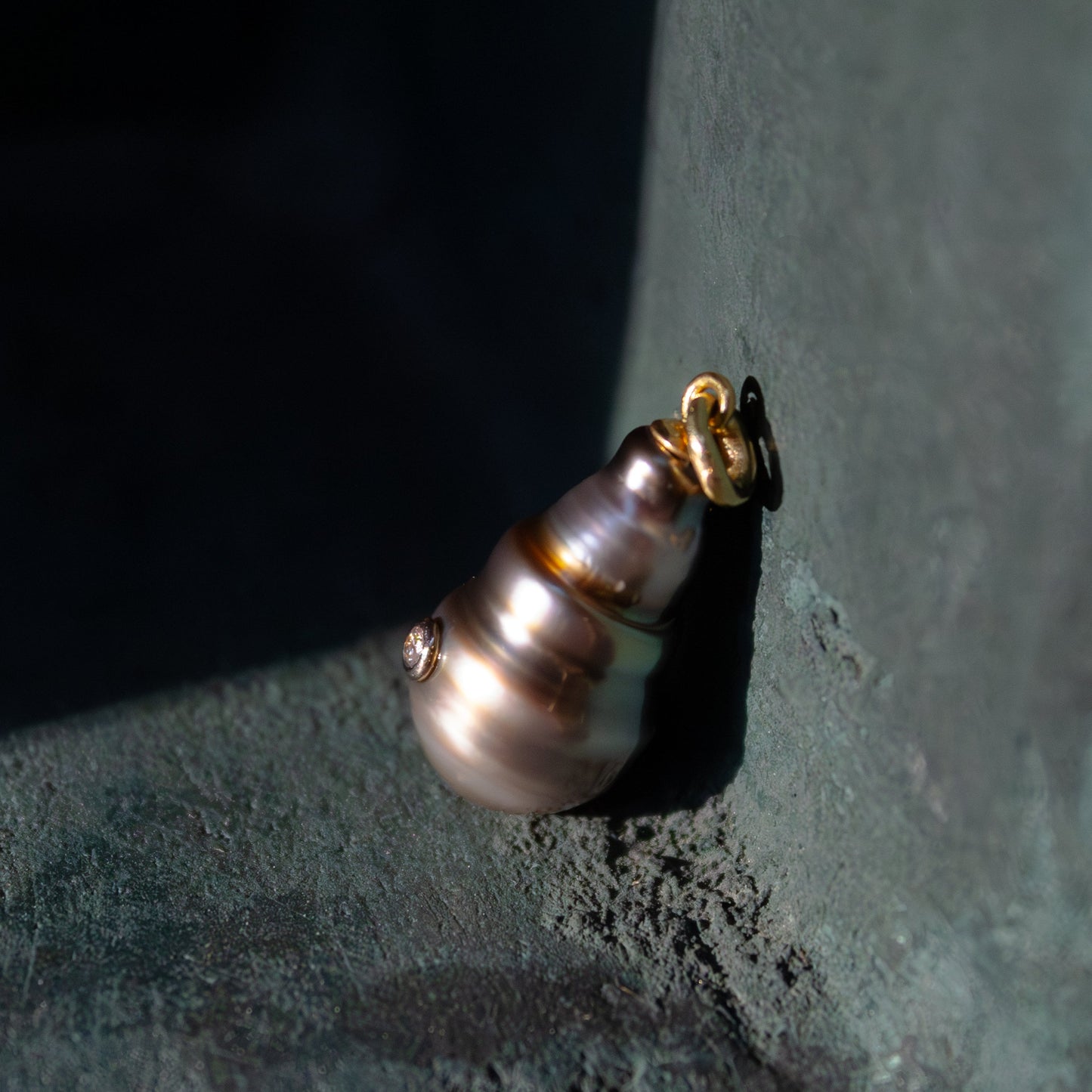 Pearl earring on a textured dark surface